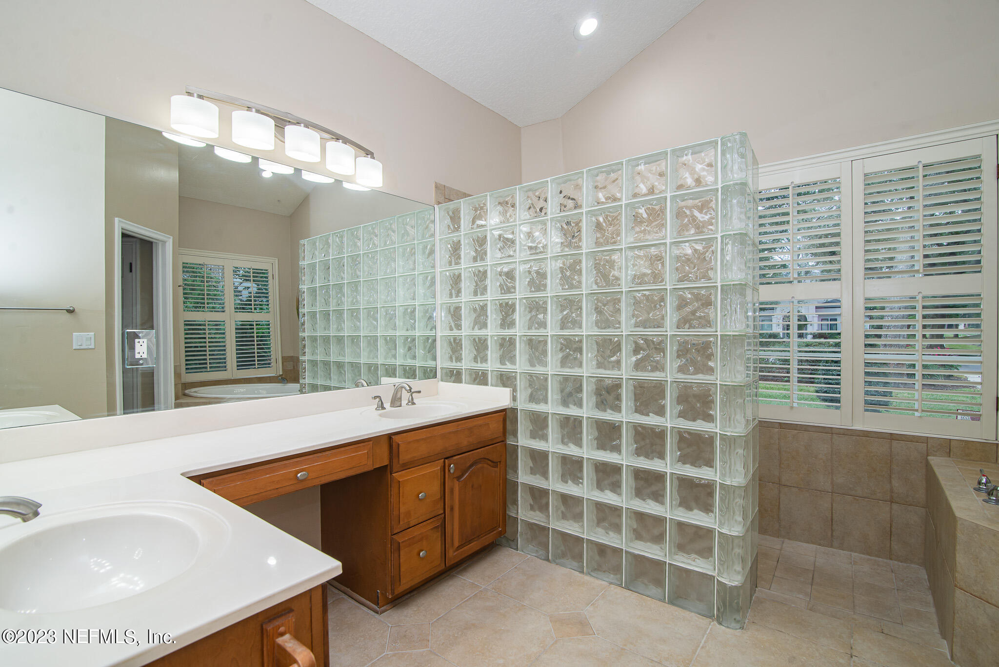 780 Queens Harbor Boulevard Jacksonville, FL 32225 - Photo 30 of 42 a spacious bathroom with a double vanity sink a mirror and a bathtub