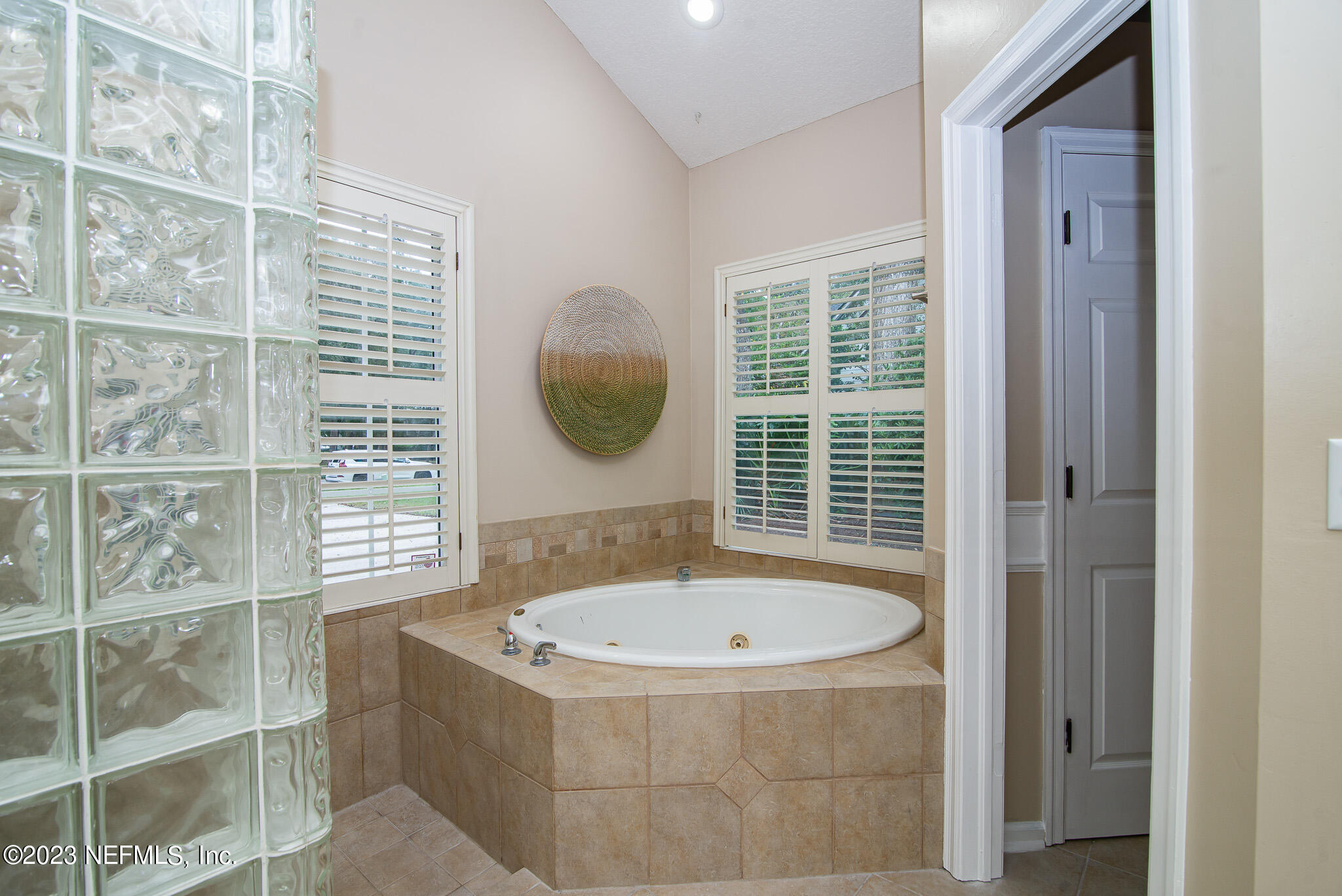 780 Queens Harbor Boulevard Jacksonville, FL 32225 - Photo 32 of 42 a bathroom with a tub and a window