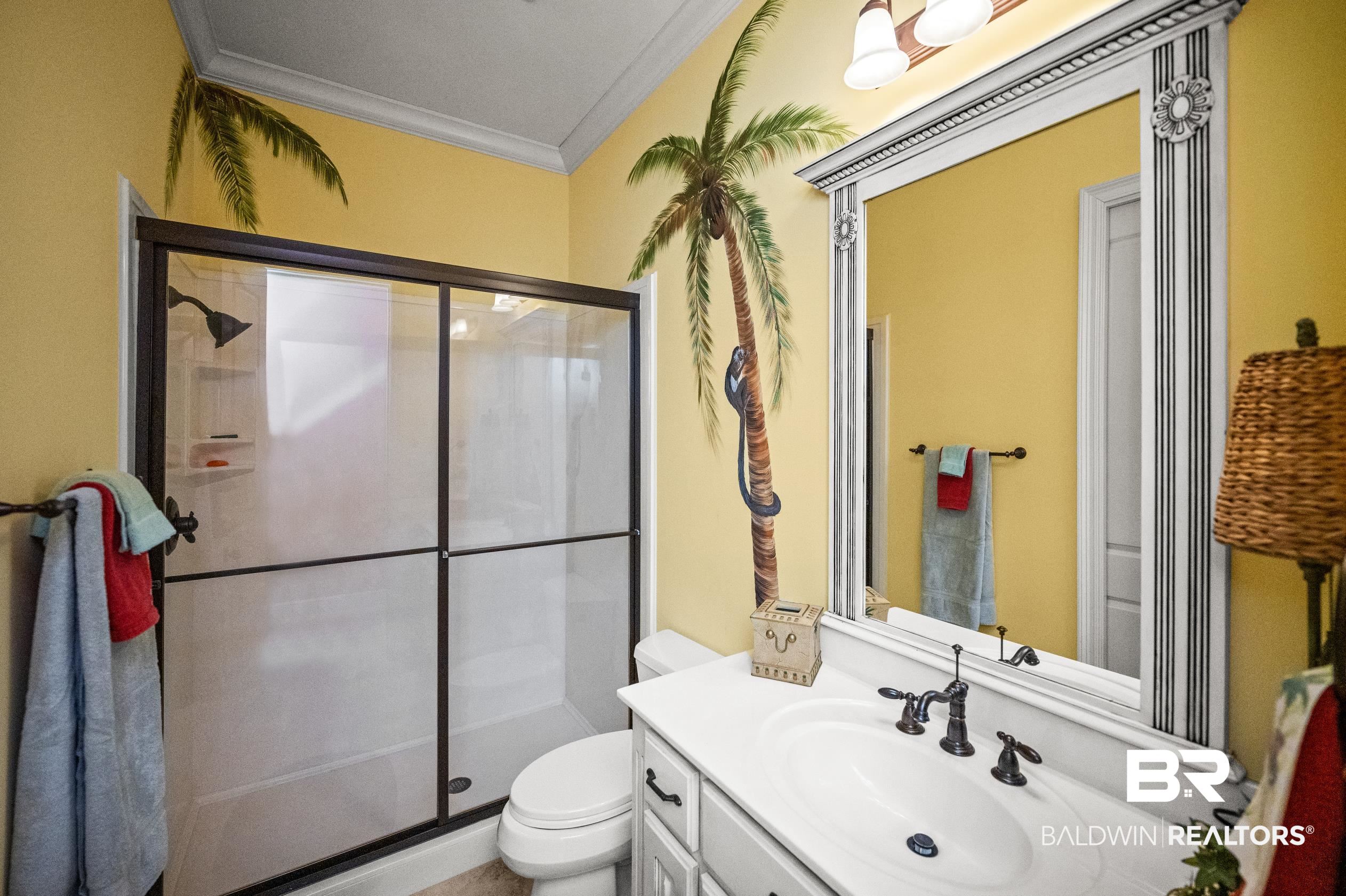 404 Peninsula Boulevard Gulf Shores, AL 36542 - Photo 14 of 51 Full bath with vanity, a shower stall, and ornamental molding