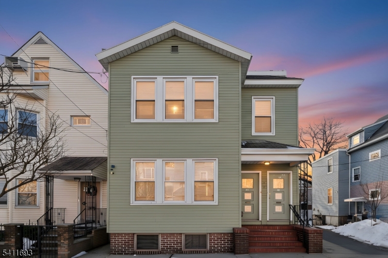 419 Hamilton Street Harrison, NJ 07029 - Photo 1 of 42 a front view of a house with parking
