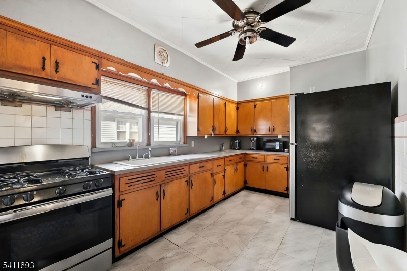 419 Hamilton Street Harrison, NJ 07029 - Photo 12 of 42 a kitchen with stainless steel appliances granite countertop a stove a refrigerator and a sink