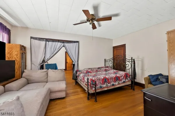 a bedroom with a bed couch and a window