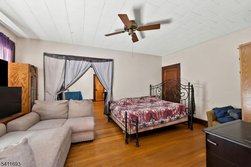 419 Hamilton Street Harrison, NJ 07029 - Photo 18 of 42 a bedroom with a bed couch and a window