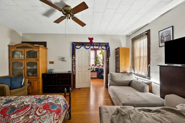 a living room with furniture a flat screen tv and kitchen view