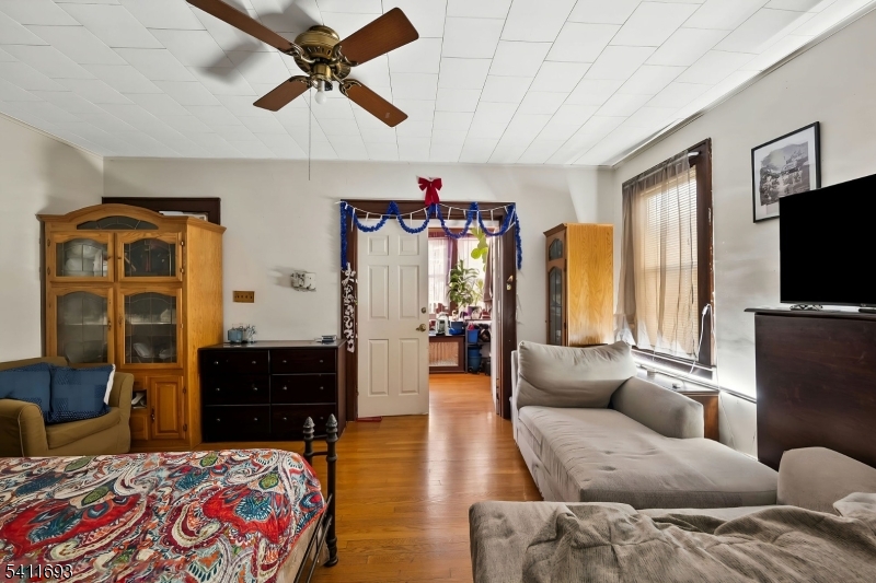 419 Hamilton Street Harrison, NJ 07029 - Photo 19 of 42 a living room with furniture a flat screen tv and kitchen view