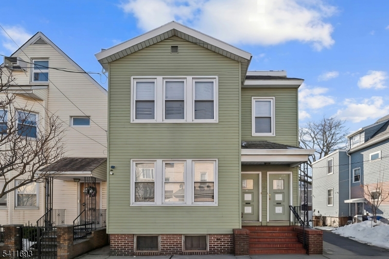 419 Hamilton Street Harrison, NJ 07029 - Photo 2 of 42 a front view of a house with parking