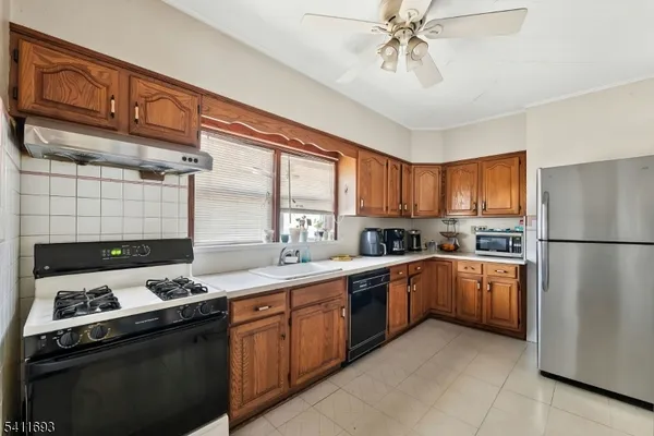 a kitchen with a sink stove and refrigerator
