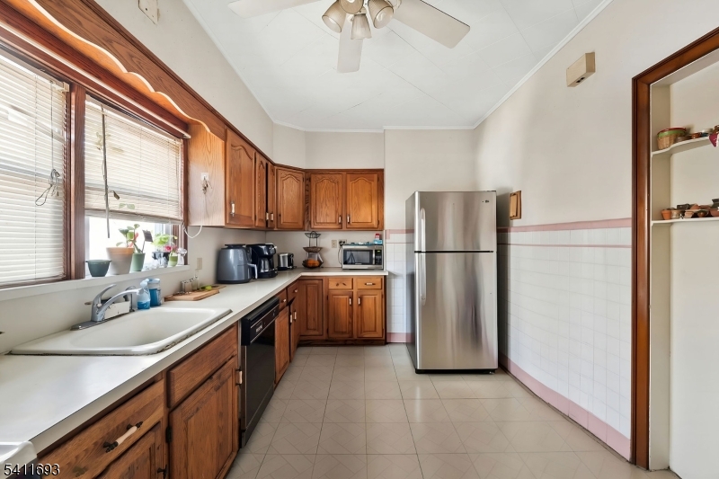 419 Hamilton Street Harrison, NJ 07029 - Photo 22 of 42 a kitchen with stainless steel appliances granite countertop a refrigerator and a sink