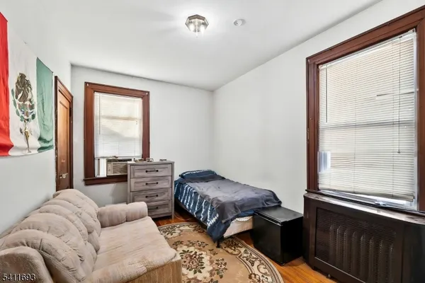 a bedroom with furniture and a large window