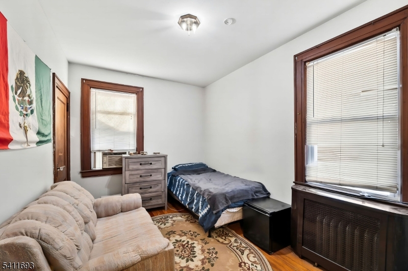 419 Hamilton Street Harrison, NJ 07029 - Photo 25 of 42 a bedroom with furniture and a large window