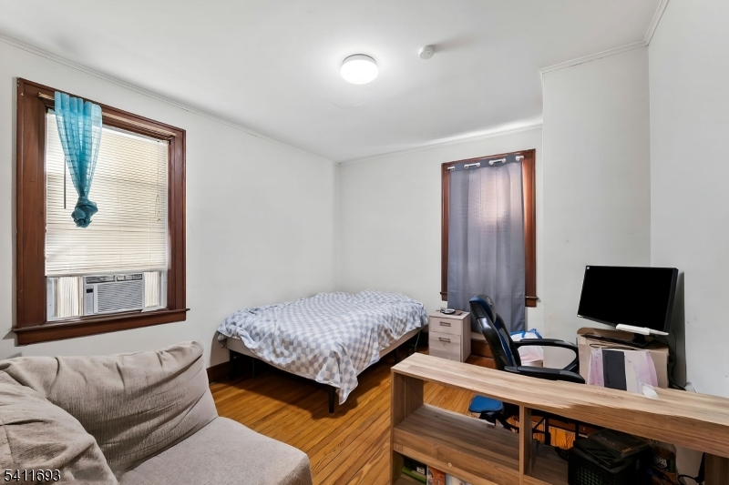 419 Hamilton Street Harrison, NJ 07029 - Photo 26 of 42 a bedroom with a bed and a flat screen tv