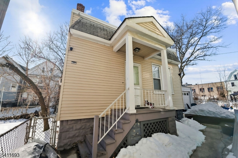 419 Hamilton Street Harrison, NJ 07029 - Photo 29 of 42 a view of a balcony with couches and wooden floor