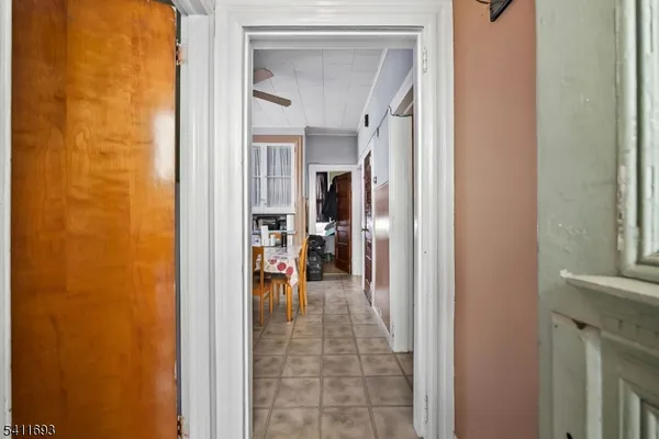 a view of a hallway with a dining room