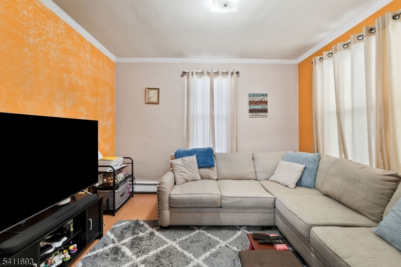 419 Hamilton Street Harrison, NJ 07029 - Photo 37 of 42 a living room with furniture and a flat screen tv