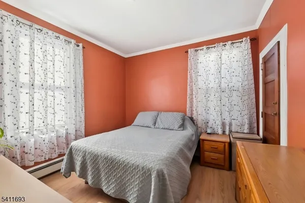 a bedroom with a bed and a large window with outer view