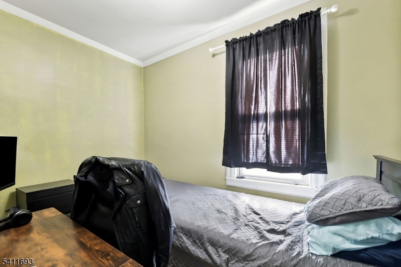 419 Hamilton Street Harrison, NJ 07029 - Photo 40 of 42 a bedroom with a bed and a window