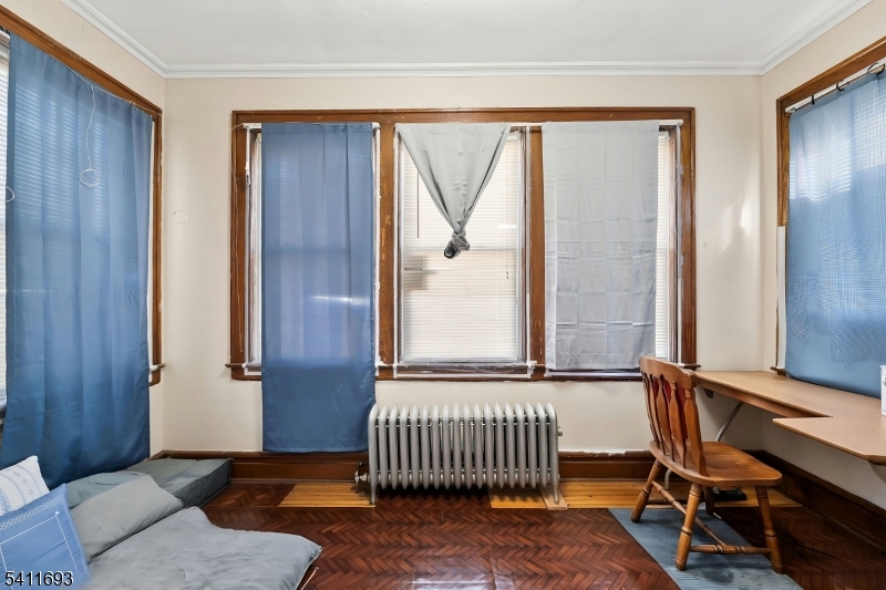 419 Hamilton Street Harrison, NJ 07029 - Photo 8 of 42 a bedroom with a bed and a window