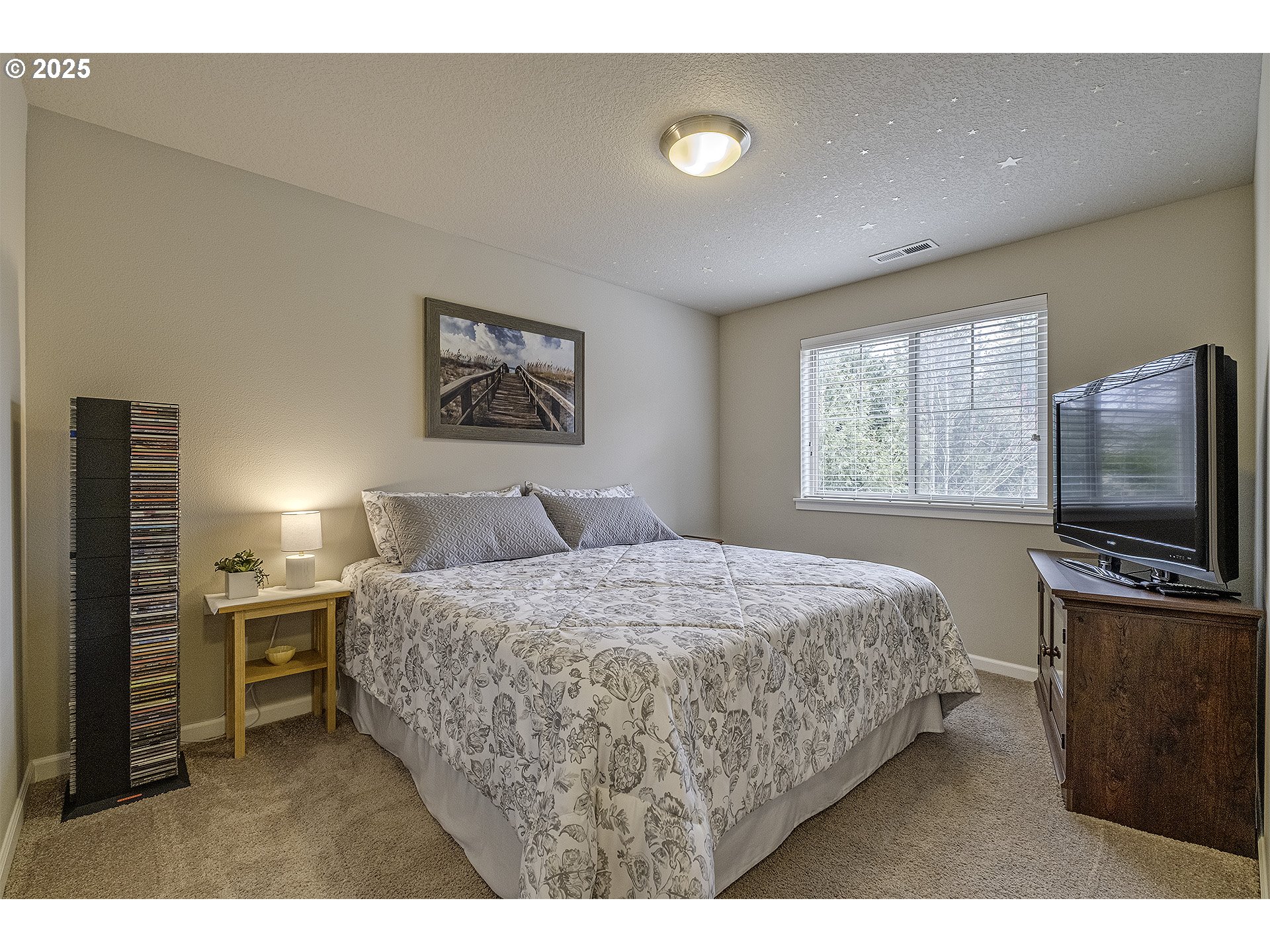 22831 Southwest Park Row Sherwood, OR 97140 - Photo 18 of 33 a bedroom with a bed and a flat screen tv