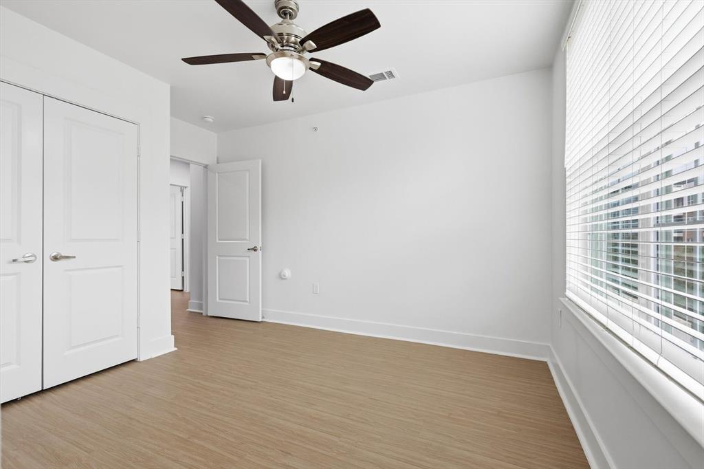 4110 Fairmount Street, Unit 1003 Dallas, TX 75219 - Photo 26 of 35 wooden floor in an empty room with a window