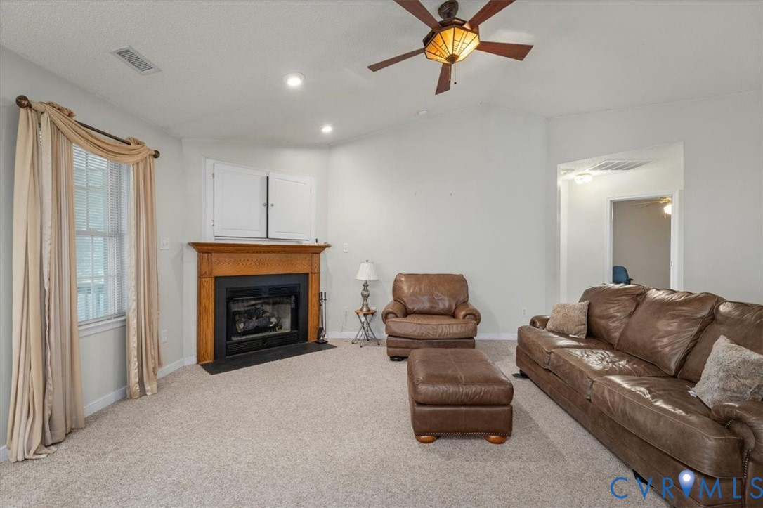 4319 Stately Oak Road North Chesterfield, VA 23234 - Photo 12 of 51 Carpeted living area featuring a fireplace with a