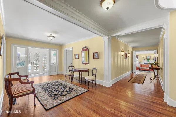 a living room with furniture and a book shelf