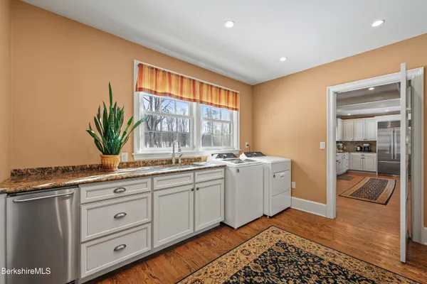 a dining room with furniture a rug and a large window