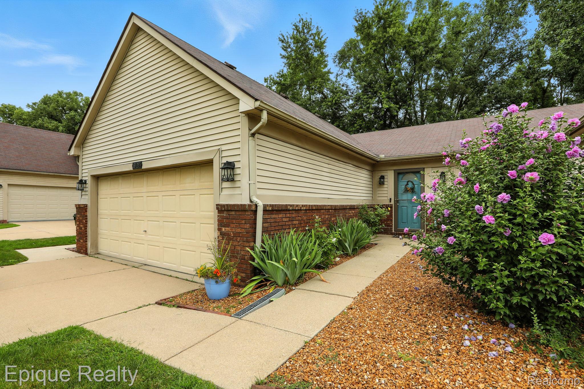 8529 22 Mile Road Utica, MI 48317 - Photo 12 of 40 View of front of property with brick siding, a garage, driveway, and a shingled roof