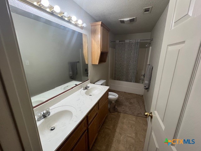 5806 Hamza Circle Killeen, TX 76542 - Photo 14 of 17 a bathroom with a sink and mirror with toilet