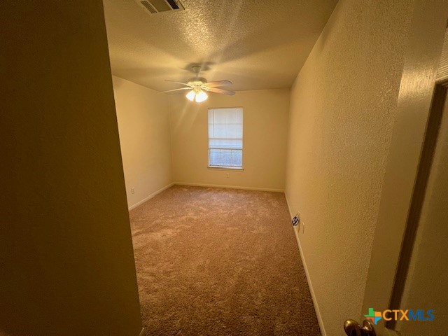 5806 Hamza Circle Killeen, TX 76542 - Photo 15 of 17 an empty room with a chandelier fan and a window