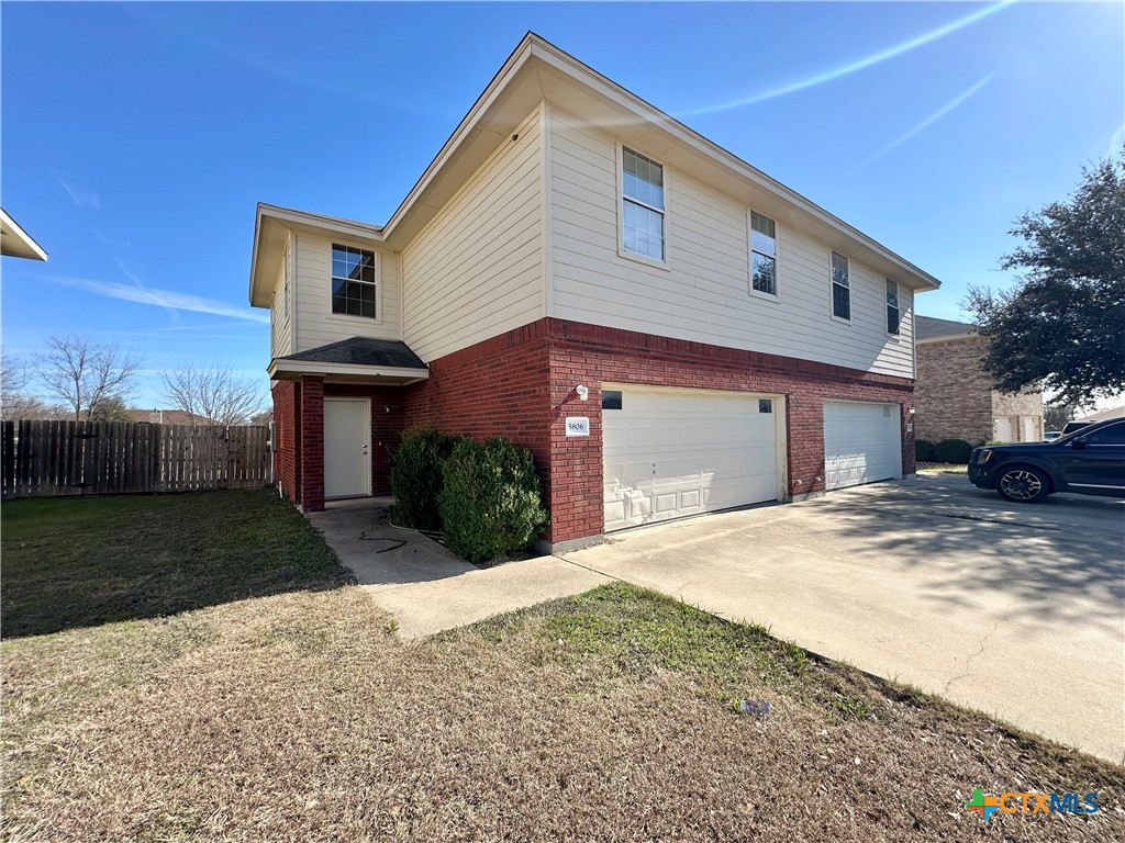 5806 Hamza Circle Killeen, TX 76542 - Photo 2 of 17 a front view of a house with a yard and garage