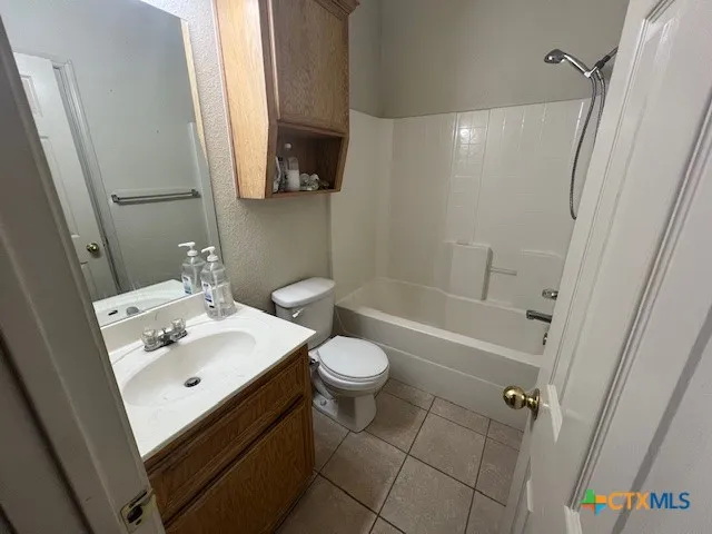 en bathroom with a granite countertop sink and a mirror