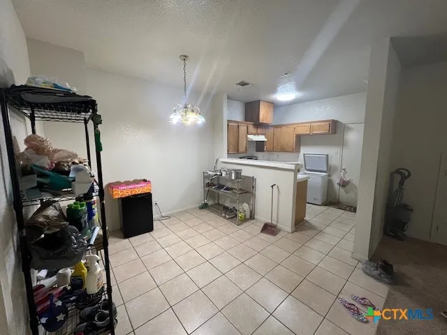 a kitchen with a sink and a refrigerator
