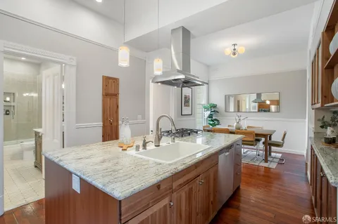 a bathroom with a granite countertop sink a toilet a mirror and shower