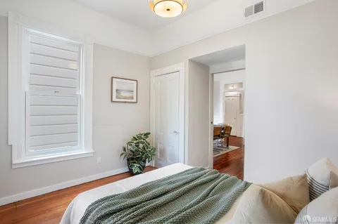 a bedroom with bed and a window