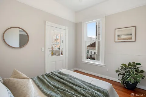 a view of a bedroom with washer and dryer