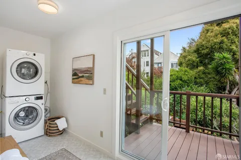 an aerial view of a house with a yard and trees all around