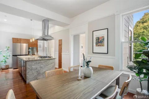 a kitchen that has a stove and a table in it