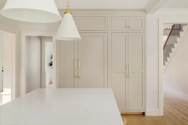 a view of a hallway to rooms