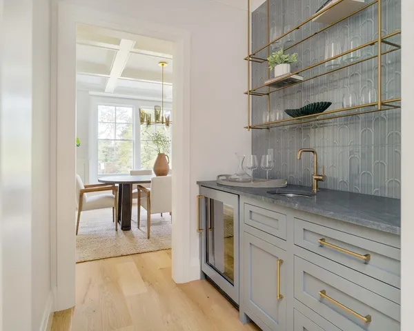 a kitchen with stainless steel appliances granite countertop a sink window and cabinets