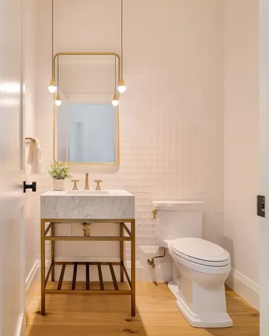 a bathroom with a toilet a sink and mirror