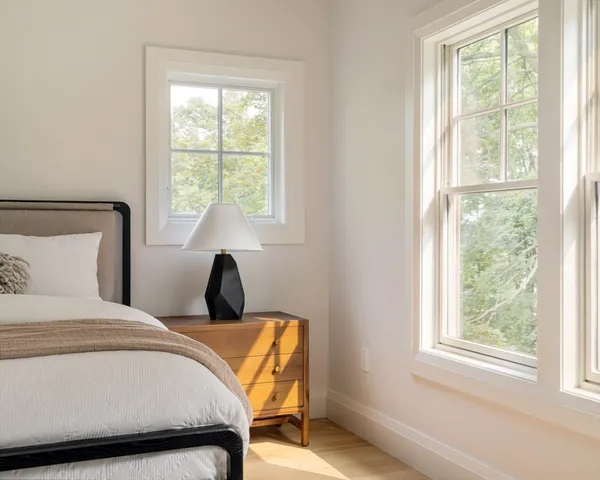 a bedroom with a bed and a window