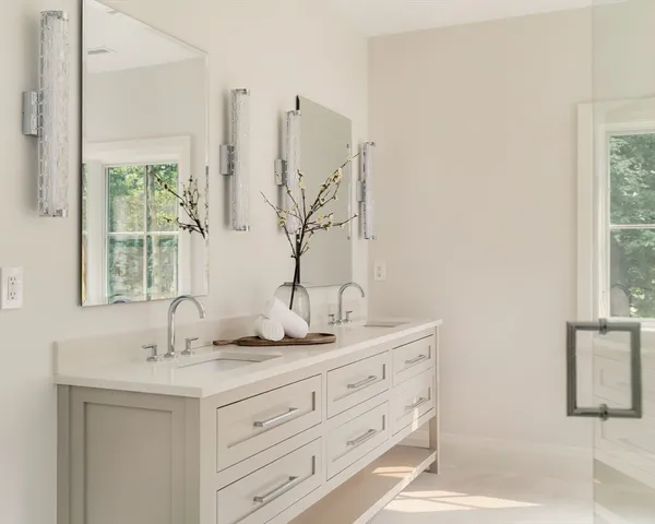 a bathroom with a double vanity sink and a window