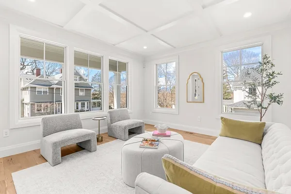 a living room with furniture a large window and a fireplace