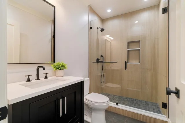 a bathroom with a sink toilet and shower