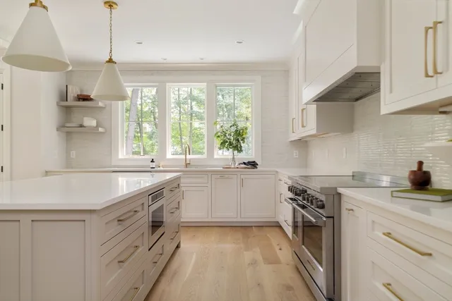 a kitchen with a sink stove and cabinets