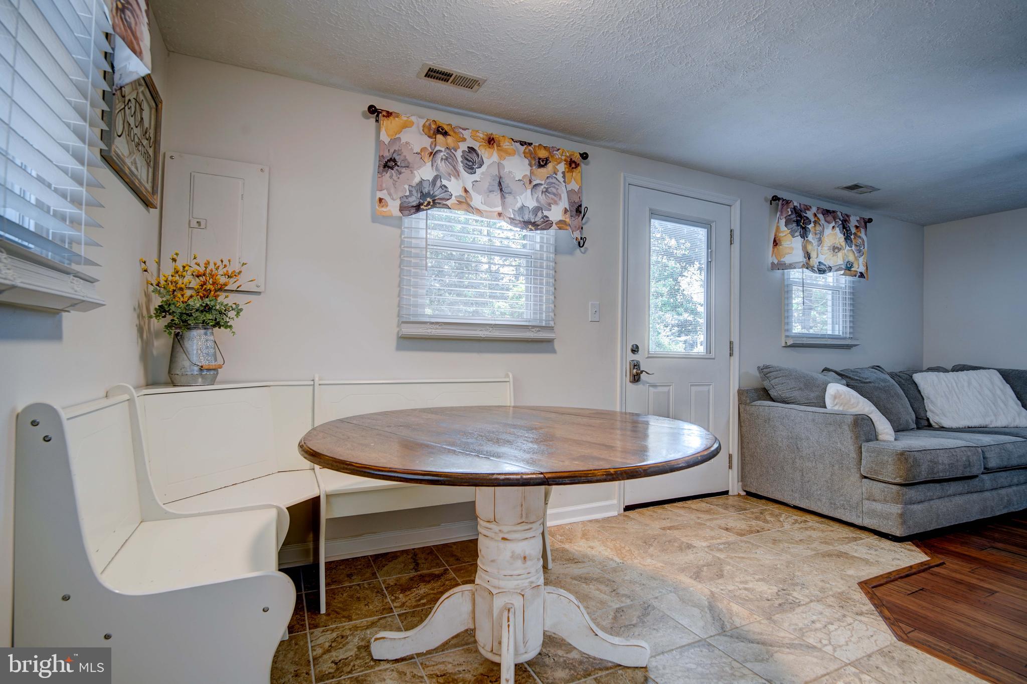 245 Newtown Road Solomons, MD 20688 - Photo 7 of 26 a living room with furniture and a table