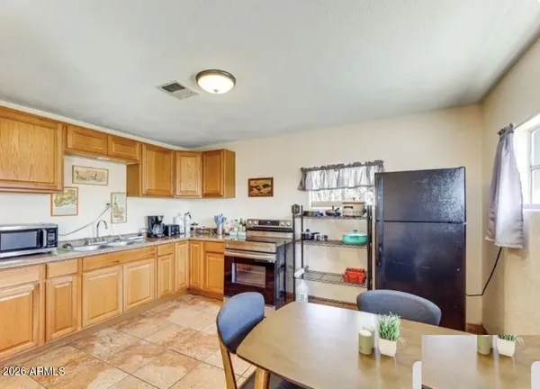 a kitchen with stainless steel appliances granite countertop a sink and cabinets