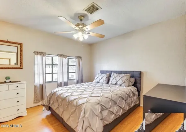 a bedroom with a large bed and a window