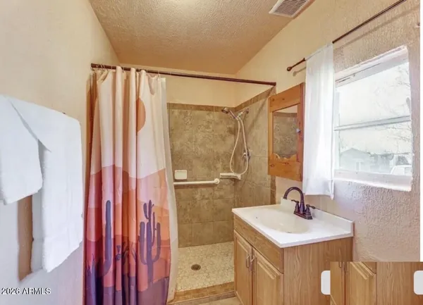 a bathroom with a sink a mirror and a shower