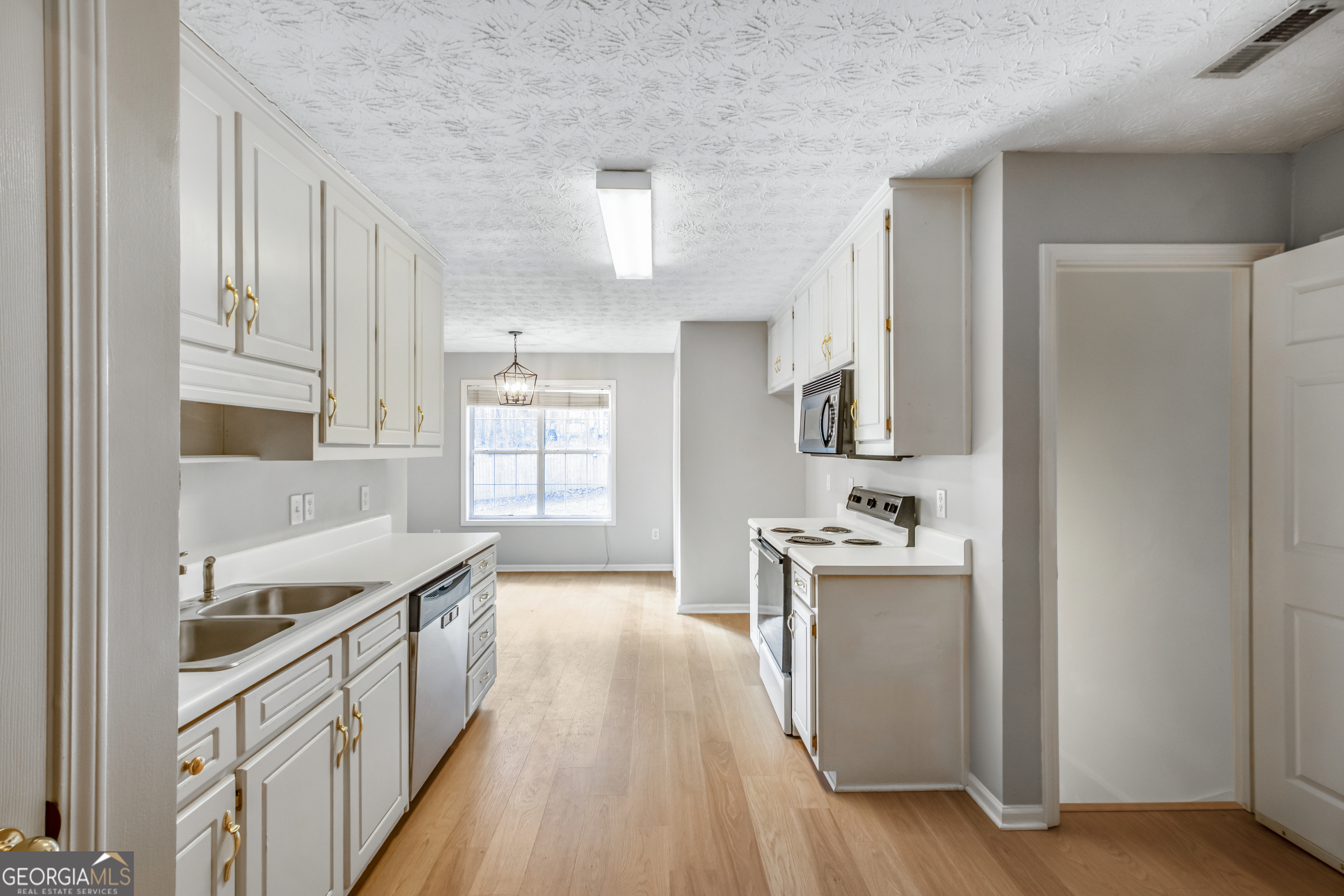 953 Azalea Court Winder, GA 30680 - Photo 13 of 56 a kitchen with granite countertop a sink stove and refrigerator